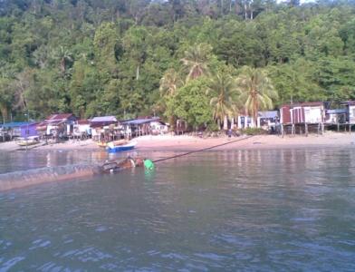 Pipe being pulled to Pangkor Island shore